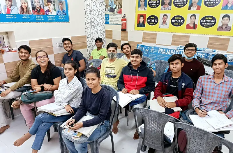 A class at Prajapati Institute, with the result banners on the wall behind